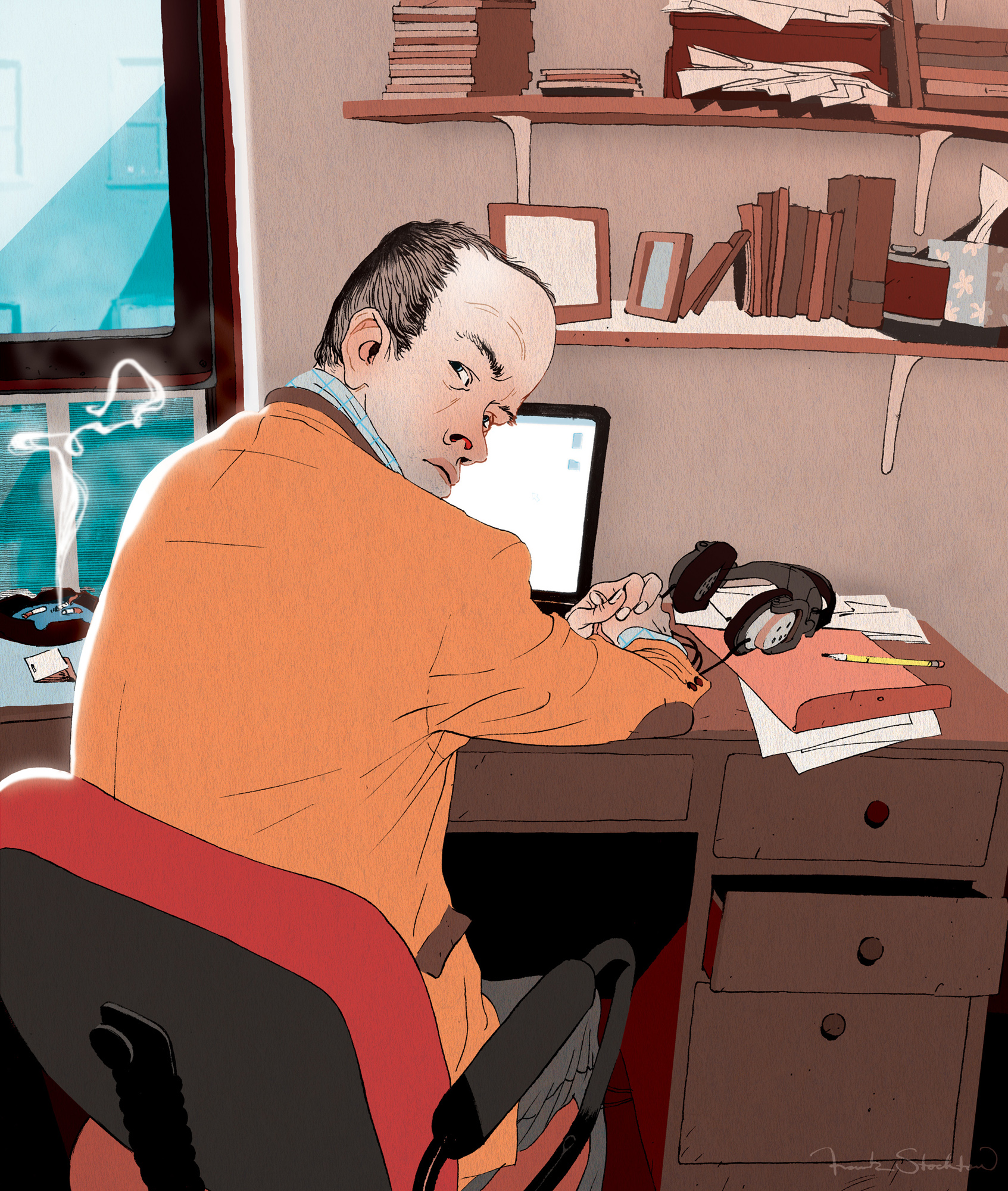 Portrait of Leo Richter seated at a desk with papers, books, and a laptop.