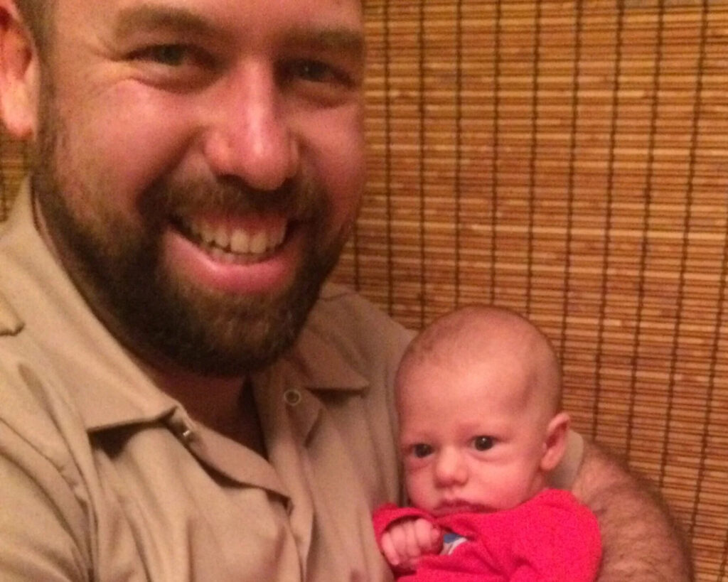 father holding his newborn baby son